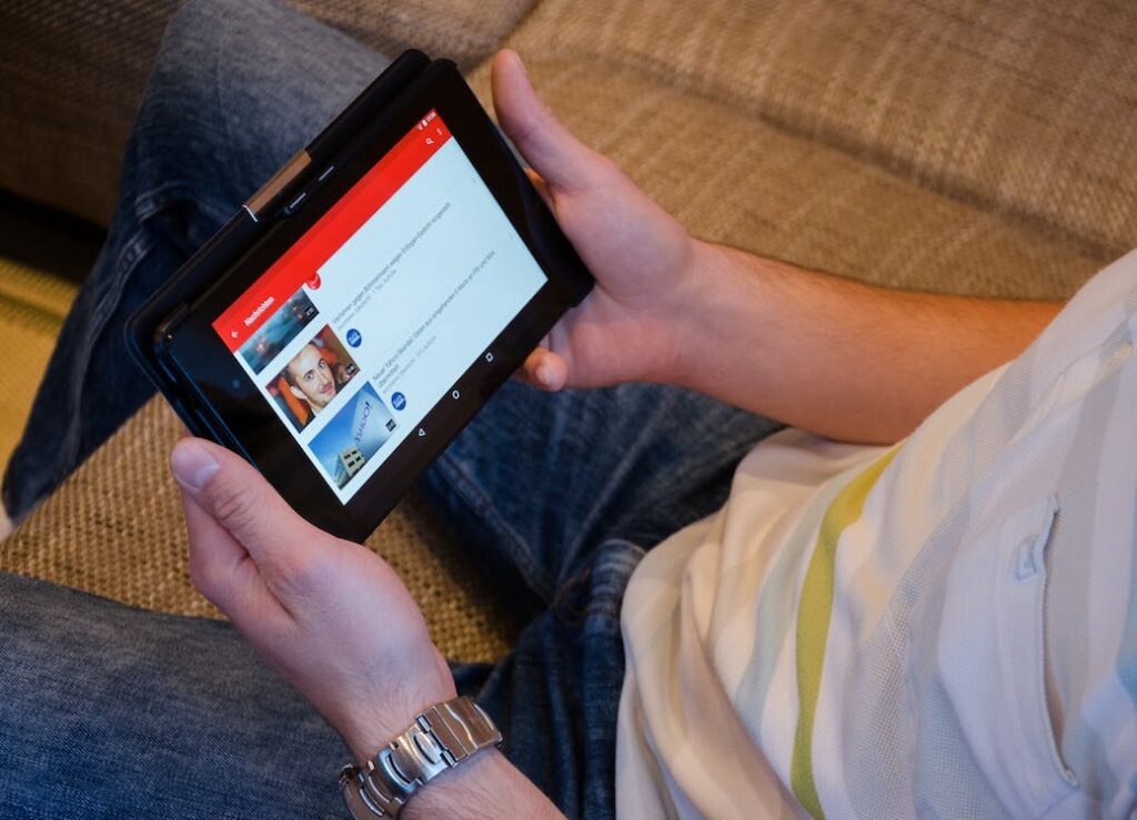 A person watching YouTube videos on their tablet