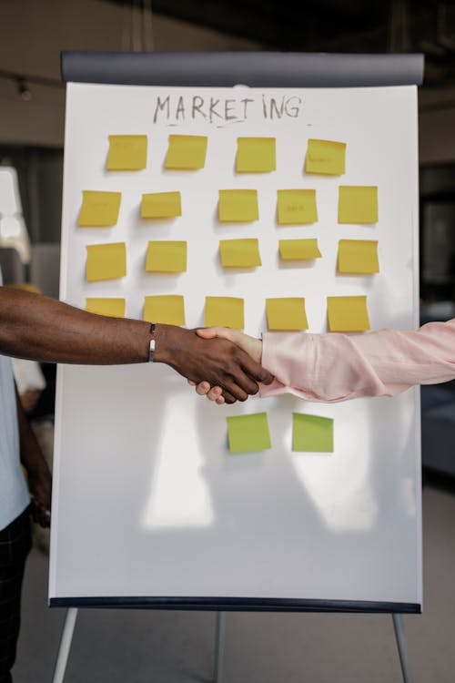 Two people shaking hands with each other