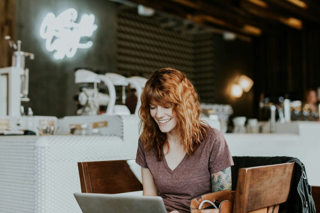 A person sitting and using their laptop