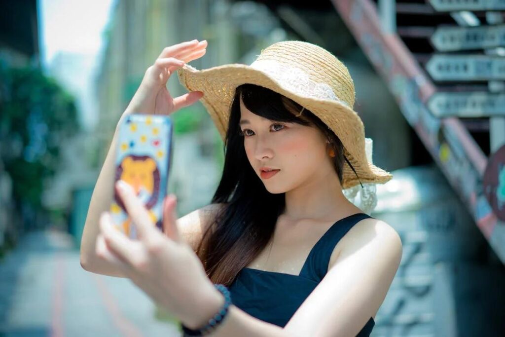 A local influencer taking a selfie with a newly built home in the background