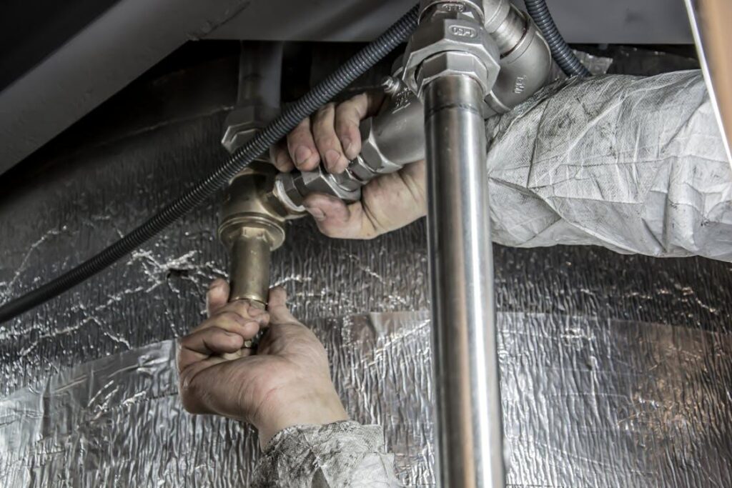 A plumber working on a pipe