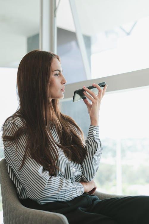 A person using a smartphone for voice search.