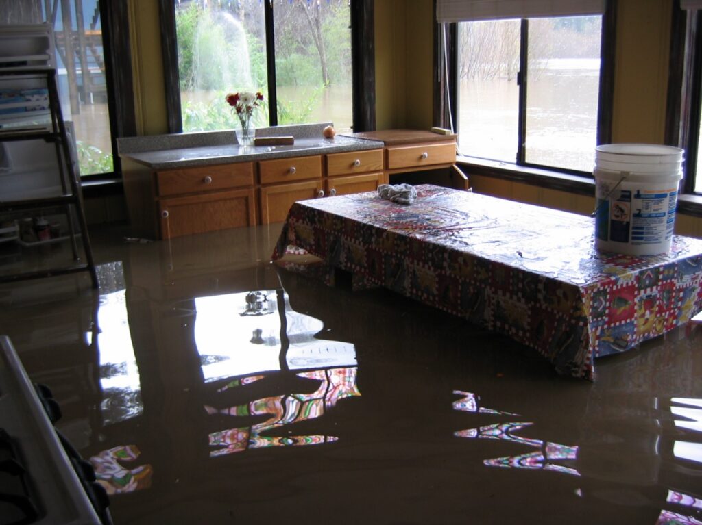 A flooded kitchen due to a DIY plumbing mistake.