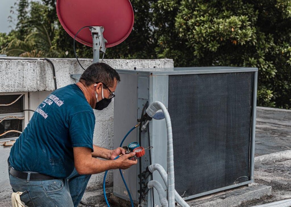 A professional HVAC technician fixing an air conditioning unit.