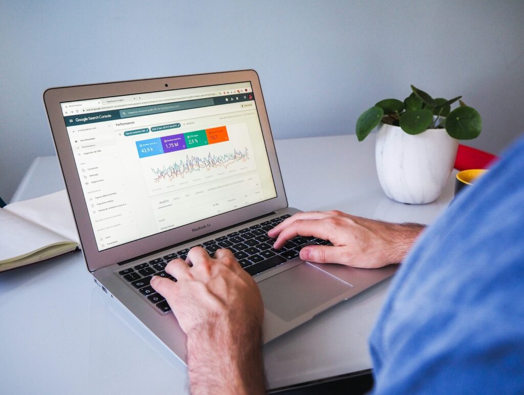 A person looking at graphs on a laptop